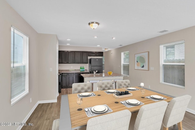 dining room featuring recessed lighting, visible vents, baseboards, and wood finished floors