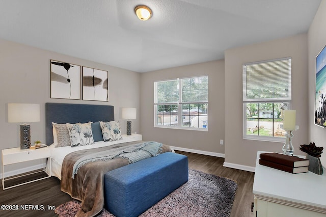 bedroom featuring baseboards and wood finished floors