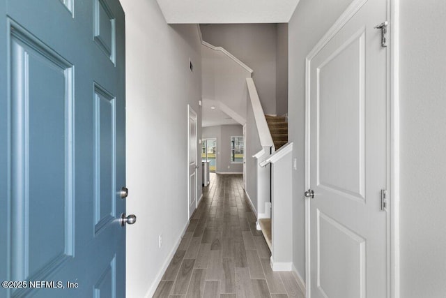 corridor with wood finished floors and baseboards