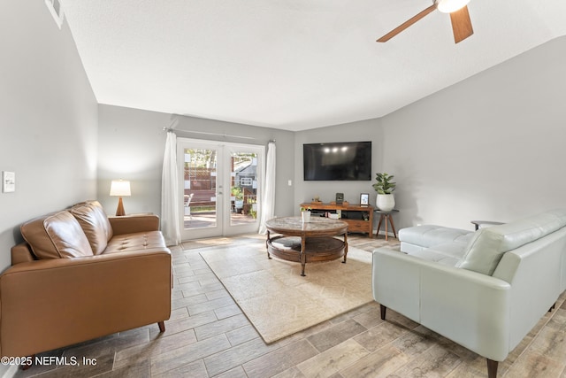 living area with ceiling fan and wood tiled floor