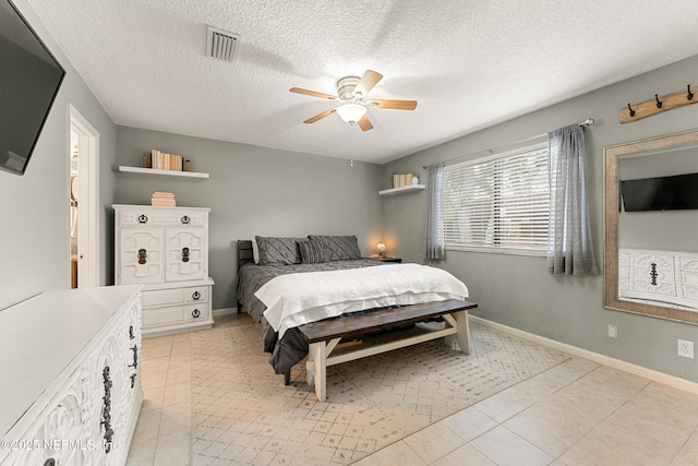 bedroom with light tile patterned flooring, visible vents, and baseboards