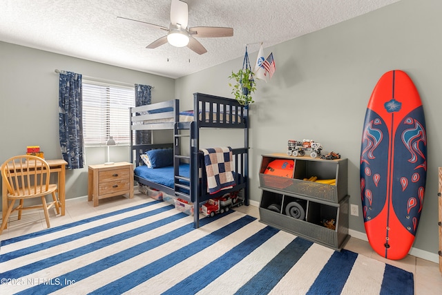 bedroom featuring baseboards, a textured ceiling, and a ceiling fan