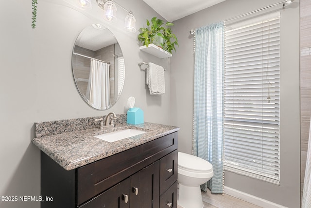 full bathroom featuring toilet, vanity, and wood finished floors