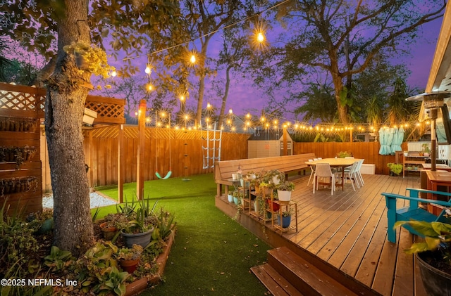 exterior space featuring a lawn, a fenced backyard, and outdoor dining space