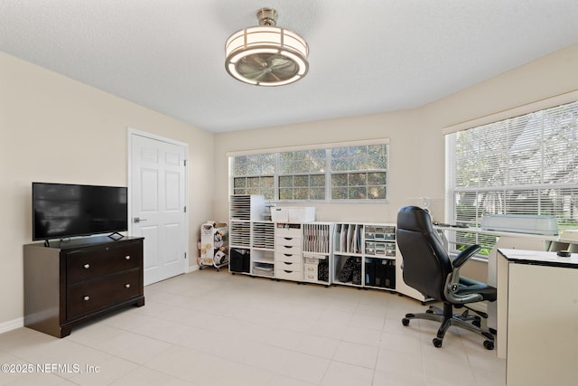 office space featuring a textured ceiling and baseboards