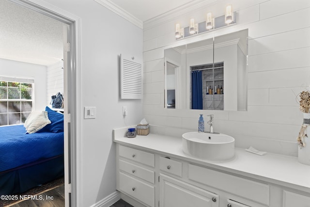 bathroom with vanity, ornamental molding, decorative backsplash, wood finished floors, and ensuite bath