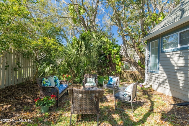 view of yard featuring an outdoor hangout area and fence