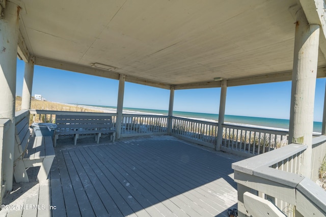 wooden terrace with a water view and a beach view