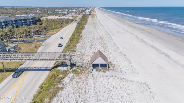 drone / aerial view featuring a water view and a beach view