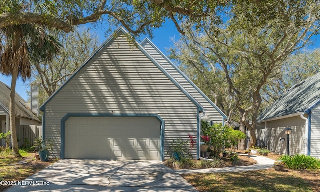 exterior space with concrete driveway and an attached garage