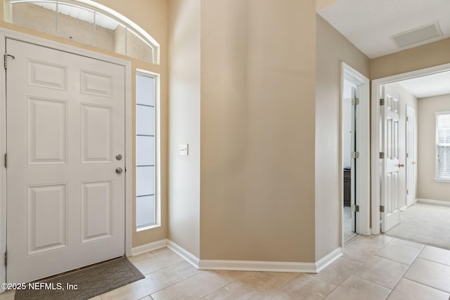 entrance foyer featuring light tile patterned floors, baseboards, and visible vents