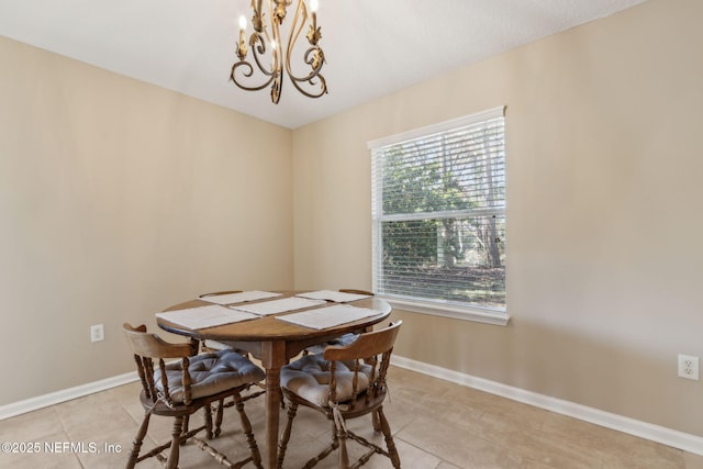 dining area with light tile patterned floors, baseboards, and a chandelier