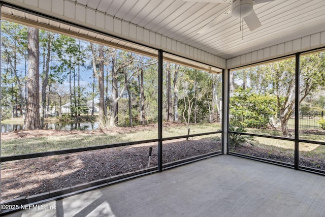 unfurnished sunroom featuring ceiling fan