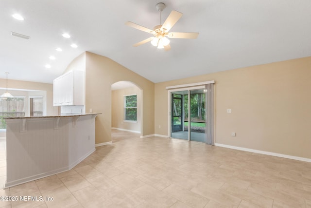 96231 Abaco Island Dr, Fernandina Beach, FL 32034 - unfurnished living room featuring vaulted ceiling, arched walkways, ceiling fan, and recessed lighting