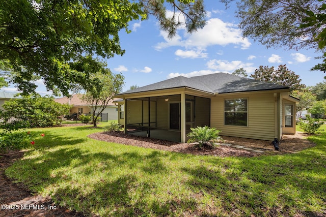96231 Abaco Island Dr, Fernandina Beach, FL 32034 - rear view of property with a sunroom, a lawn, and roof with shingles