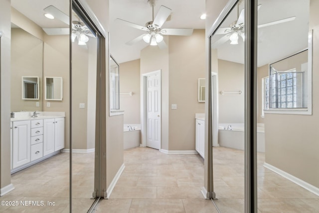 96231 Abaco Island Dr, Fernandina Beach, FL 32034 - bathroom featuring ceiling fan, vanity, a bath, tile patterned flooring, and lofted ceiling