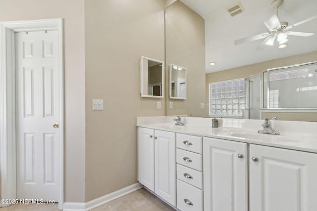 96231 Abaco Island Dr, Fernandina Beach, FL 32034 - full bathroom with double vanity, ceiling fan, a shower with shower door, and tile patterned flooring