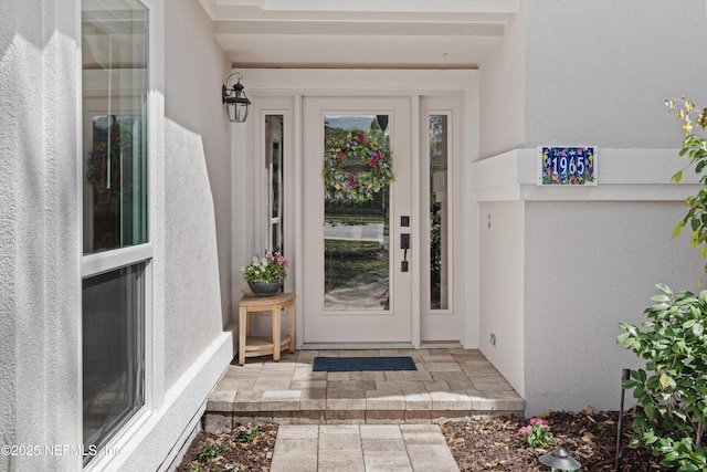 entrance to property with stucco siding