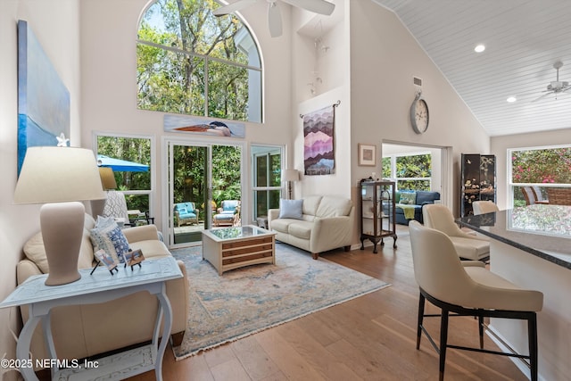 living area featuring recessed lighting, wood-type flooring, high vaulted ceiling, and ceiling fan