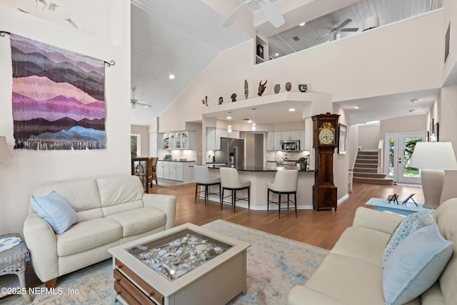 living room featuring recessed lighting, high vaulted ceiling, ceiling fan, and wood finished floors