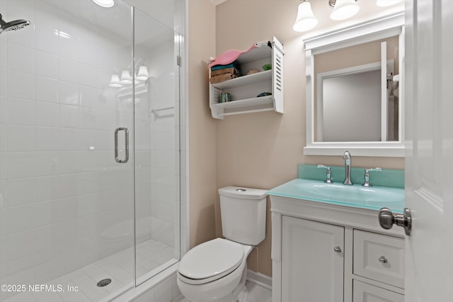 full bath featuring vanity, toilet, baseboards, and a stall shower