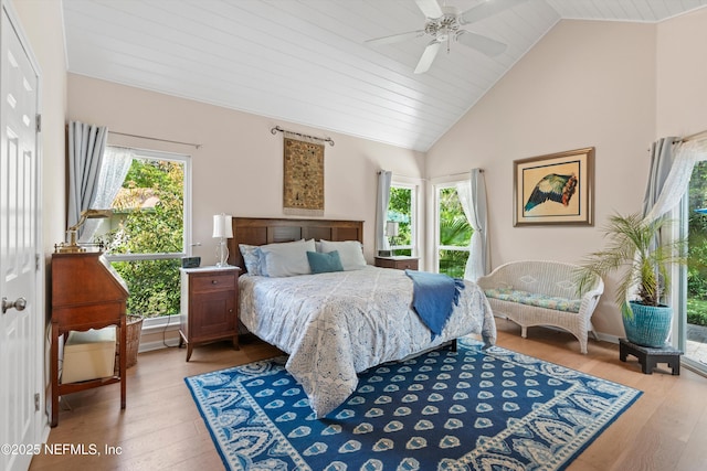 bedroom featuring a ceiling fan, wood ceiling, wood finished floors, and high vaulted ceiling