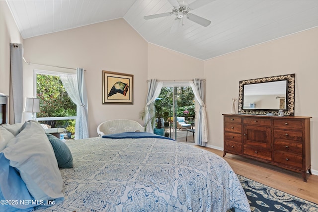 bedroom with vaulted ceiling, multiple windows, wood finished floors, and ceiling fan