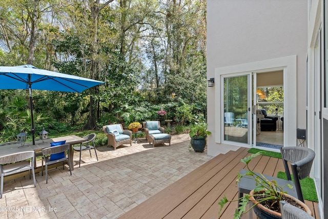 view of patio featuring outdoor dining space and a deck