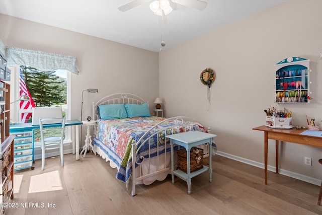 bedroom featuring wood finished floors, baseboards, and ceiling fan