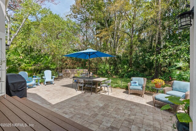 view of patio with outdoor dining space and a grill