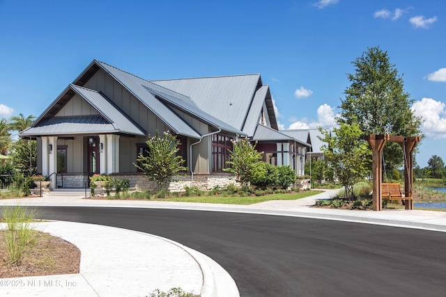 exterior space featuring board and batten siding, metal roof, and a standing seam roof