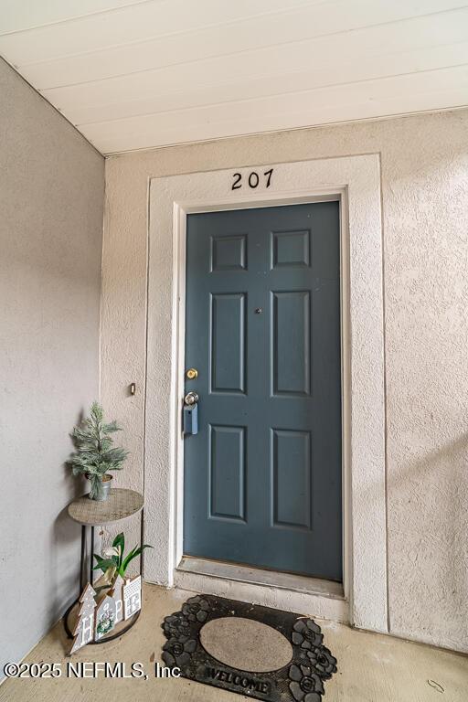 property entrance featuring stucco siding