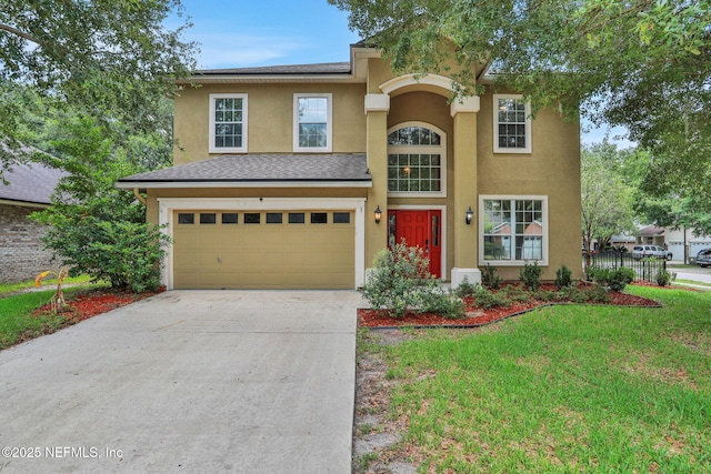 1601 Majestic View Ln, Fleming Island, FL 32003 - view of front of home featuring an attached garage, concrete driveway, stucco siding, and a front yard