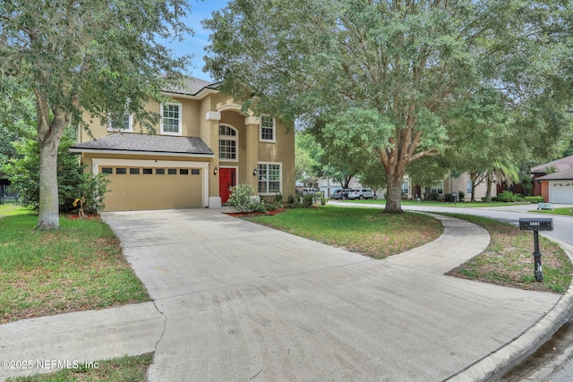 1601 Majestic View Ln, Fleming Island, FL 32003 - traditional-style home featuring stucco siding, driveway, an attached garage, and a front yard