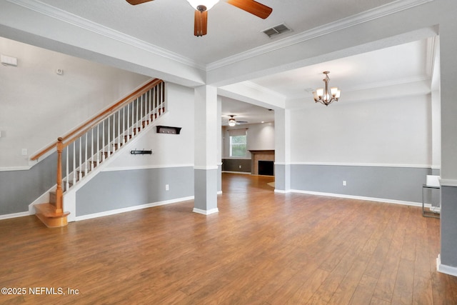 1601 Majestic View Ln, Fleming Island, FL 32003 - unfurnished living room featuring ceiling fan, stairway, wood finished floors, crown molding, and a fireplace