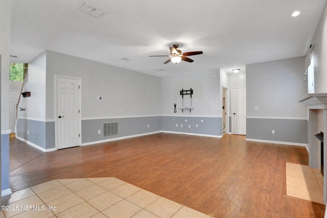 1601 Majestic View Ln, Fleming Island, FL 32003 - unfurnished living room featuring a ceiling fan, wood finished floors, a fireplace with flush hearth, and recessed lighting