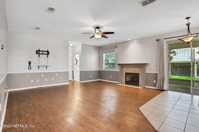 1601 Majestic View Ln, Fleming Island, FL 32003 - unfurnished living room featuring ceiling fan, wood finished floors, and a glass covered fireplace