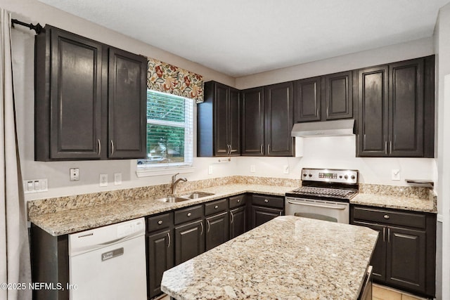 1601 Majestic View Ln, Fleming Island, FL 32003 - kitchen with stainless steel electric range, white dishwasher, under cabinet range hood, a center island, and light stone counters