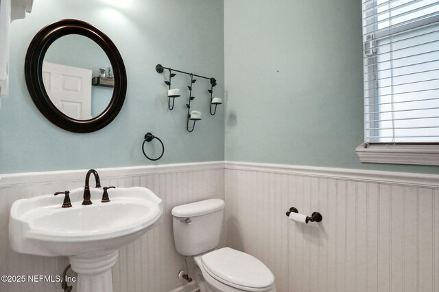 1601 Majestic View Ln, Fleming Island, FL 32003 - half bathroom featuring a wainscoted wall and toilet