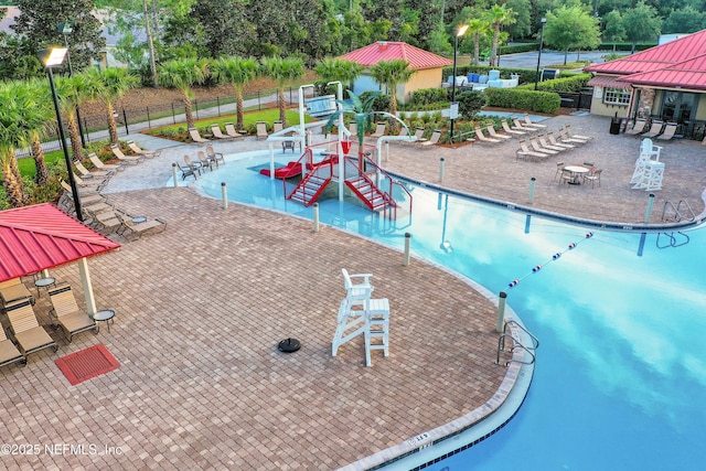 1601 Majestic View Ln, Fleming Island, FL 32003 - community pool with a water play area, a water slide, and view of wooded area