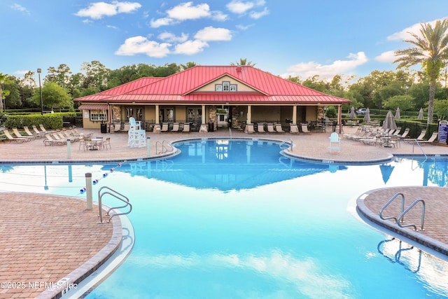 1601 Majestic View Ln, Fleming Island, FL 32003 - community pool featuring a patio area and view of wooded area