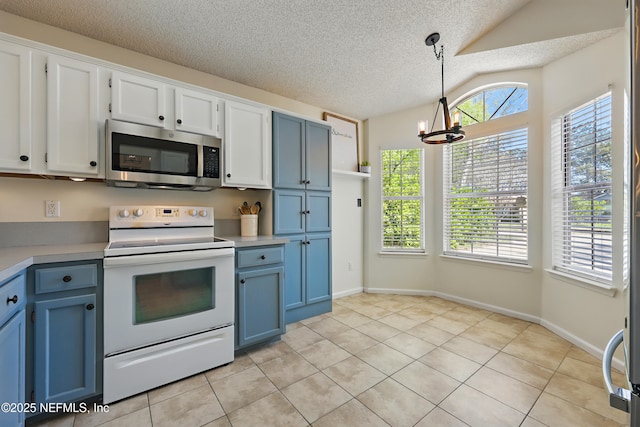 kitchen with light tile patterned flooring, stainless steel microwave, blue cabinetry, and electric range