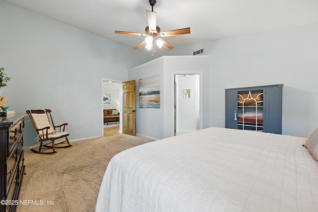 carpeted bedroom with visible vents, baseboards, ceiling fan, and vaulted ceiling