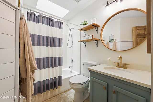 full bath with tile patterned floors, toilet, shower / bath combo, a skylight, and vanity