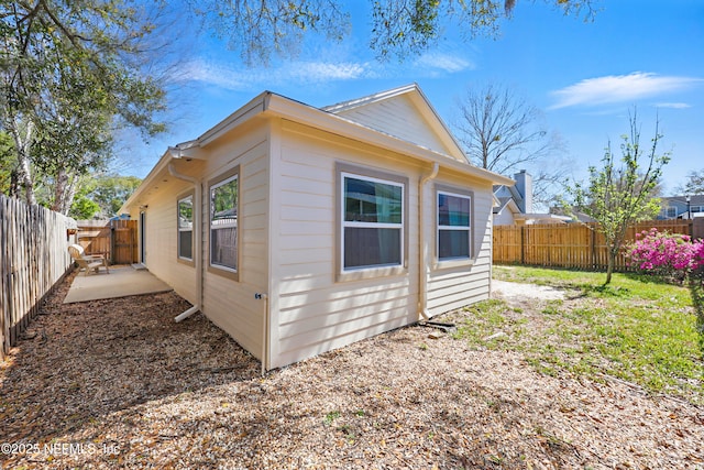 view of home's exterior with a patio and a fenced backyard