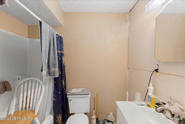 bathroom featuring toilet, a textured ceiling, vanity, and shower / bath combo with shower curtain