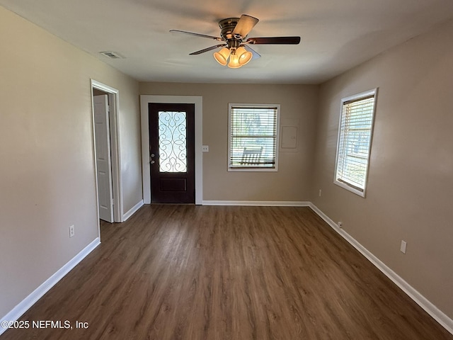 foyer entrance featuring visible vents, baseboards, ceiling fan, and dark wood-style flooring