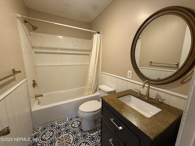 full bathroom featuring tile patterned flooring, wainscoting, toilet, and shower / tub combo with curtain