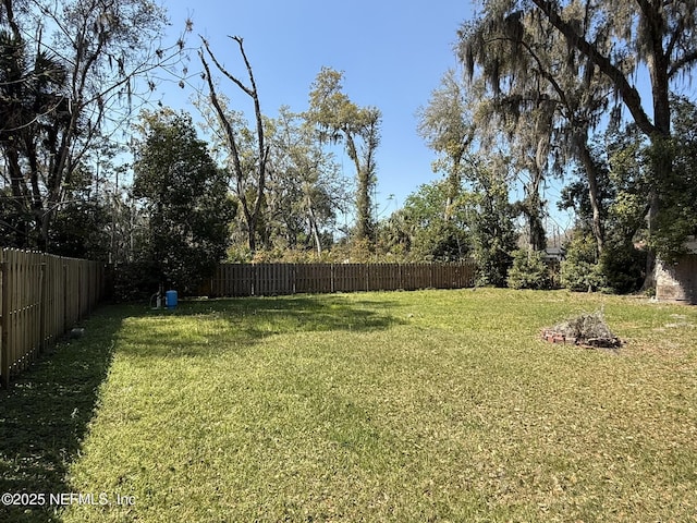 view of yard with a fenced backyard