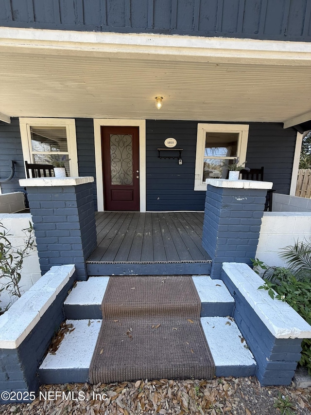 property entrance featuring board and batten siding